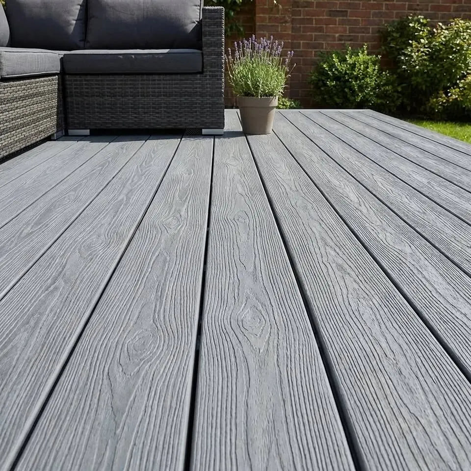 Grey woodgrain composite decking on a garden terrace with rattan seating