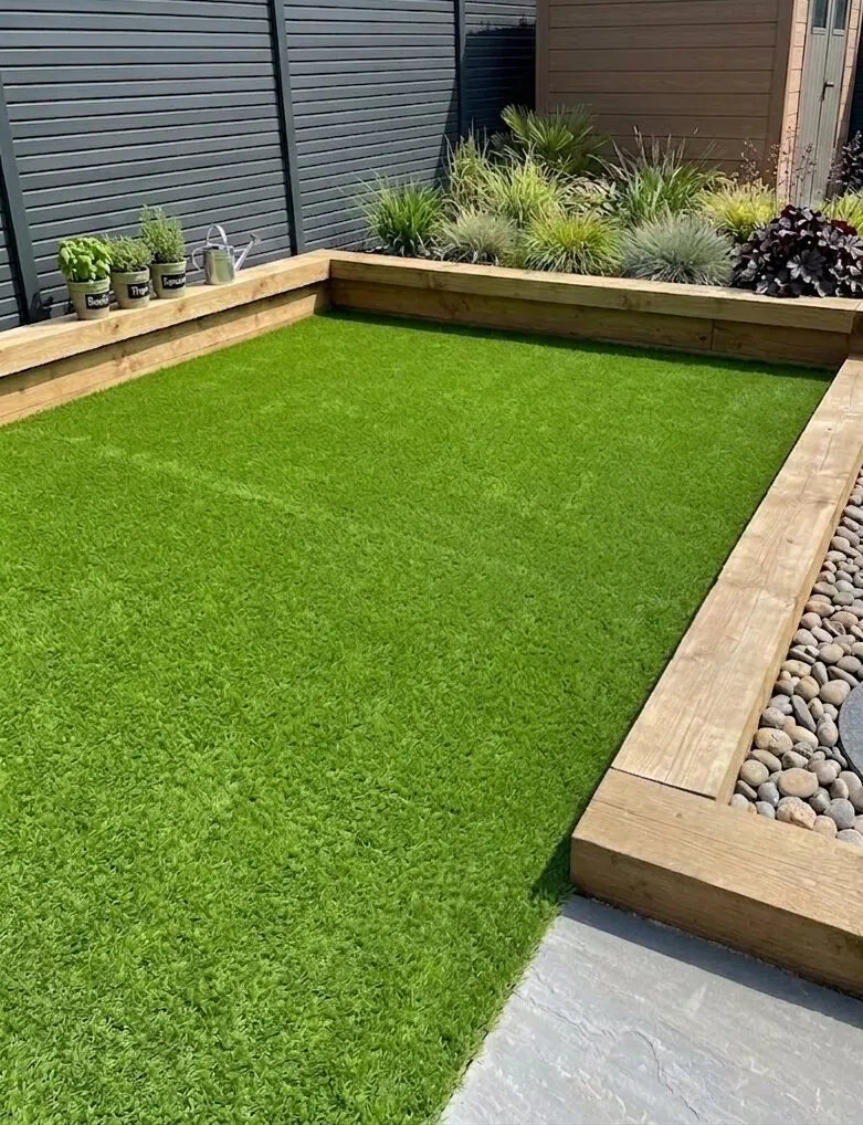 Artificial grass lawn edged with timber sleepers in a modern back garden