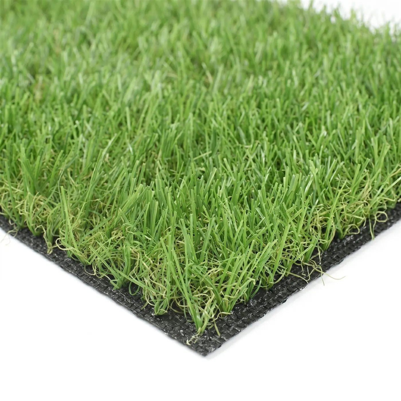 Close-up of an artificial grass sample showing the green pile and black latex backing