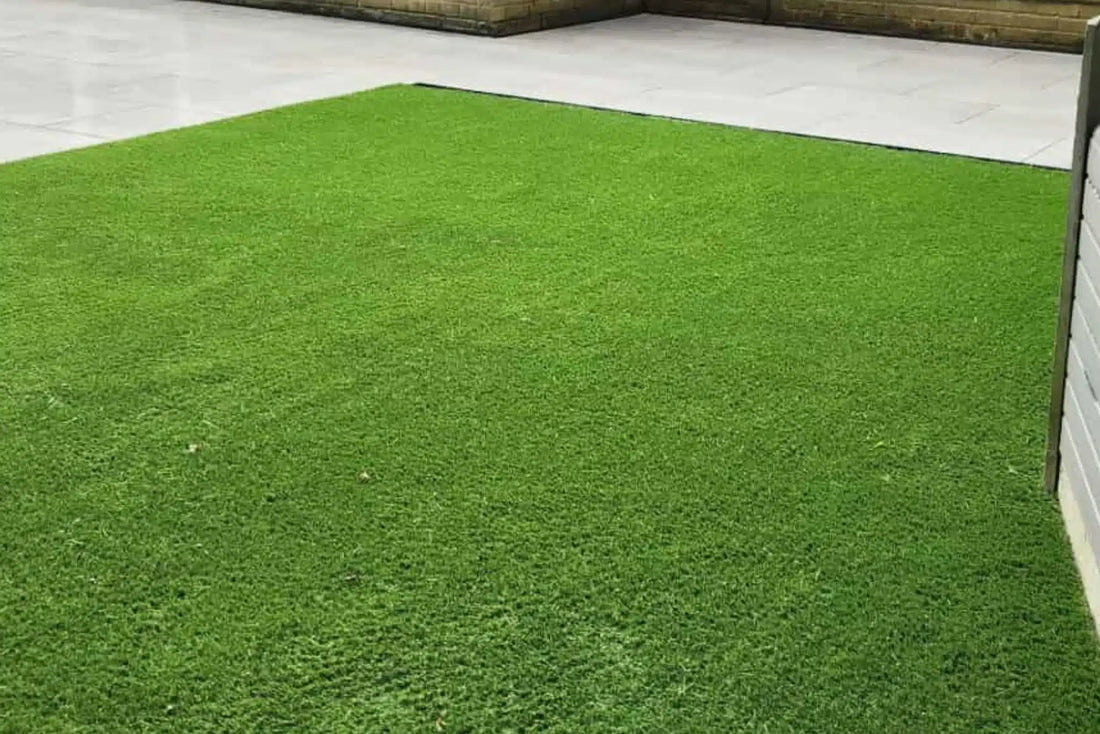 A finished artificial lawn meeting a paved edge, the kind of clean rectangle this guide shows you how to measure