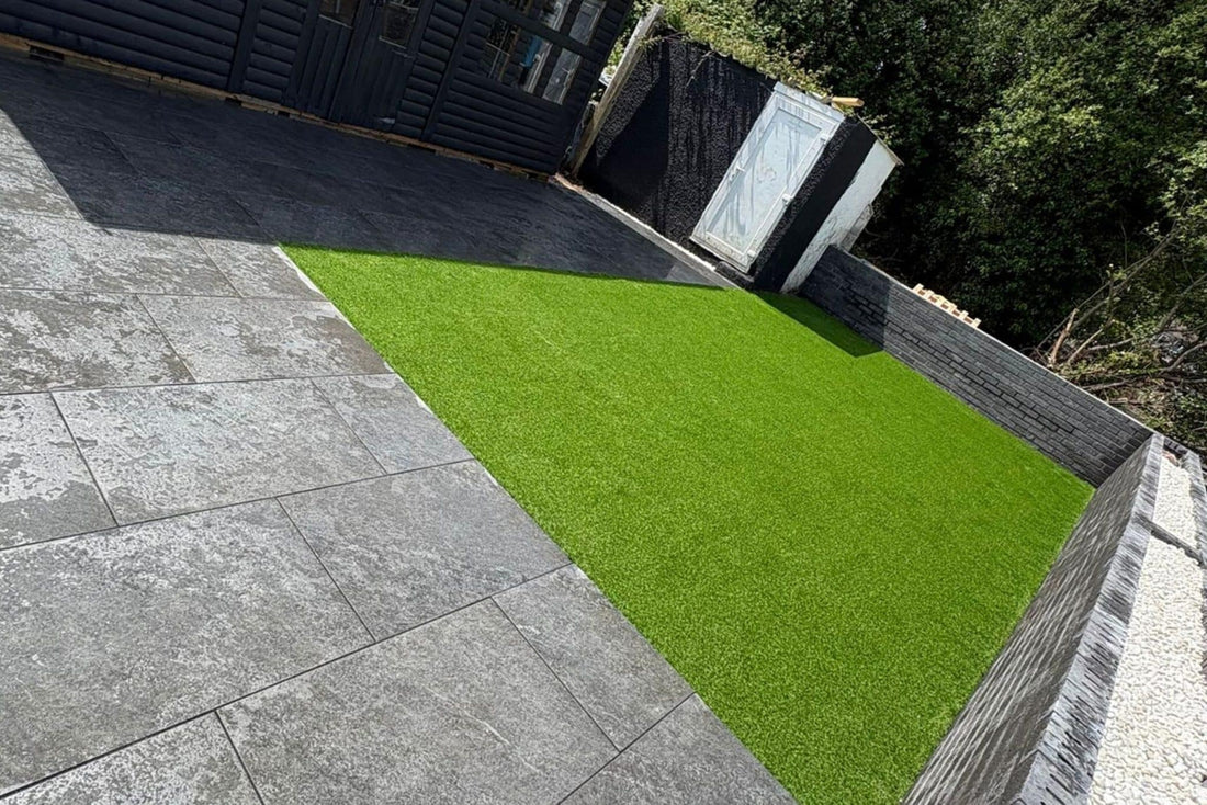 An artificial lawn laid against paving in a domestic garden